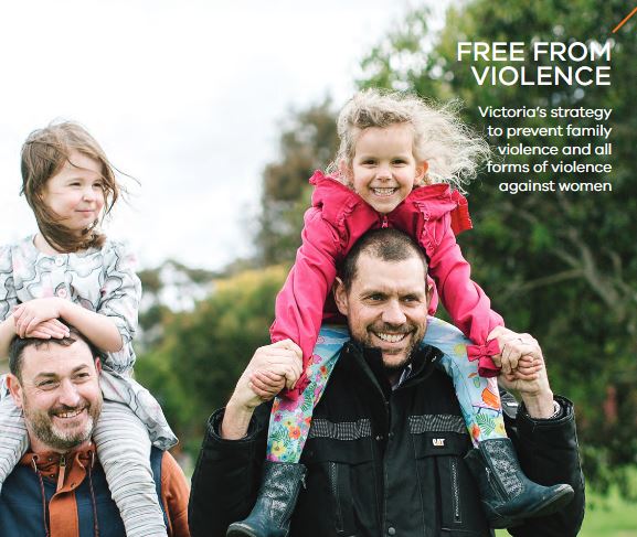 Two fathers om a park with kids on their shoulders